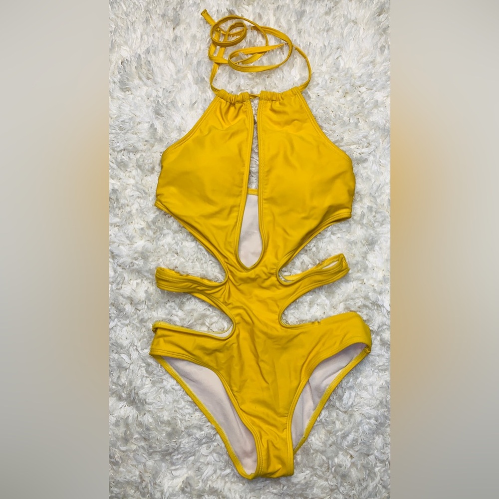 Yellow one-piece swimsuit with cutouts. Size Medium